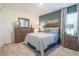 Comfortable bedroom with a striped bedspread, dresser, and bedside tables at 307 Corsica Ct, Kissimmee, FL 34758