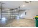 Spacious two car garage with overhead lighting, offering ample parking and storage solutions at 307 Corsica Ct, Kissimmee, FL 34758