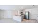 Open-concept kitchen boasts a center island with a sink and modern stainless steel appliances including a refrigerator at 307 Corsica Ct, Kissimmee, FL 34758