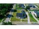 An aerial view showing the home, its landscaped front yard, long driveway, and neighborhood setting at 311 W Delaware Ave, Lake Helen, FL 32744