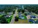 An aerial view capturing homes in a neighborhood setting complete with green lawns and mature trees at 311 W Delaware Ave, Lake Helen, FL 32744