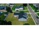 An aerial photograph showing the home's backyard, including the wooden deck and surrounding lawn at 311 W Delaware Ave, Lake Helen, FL 32744