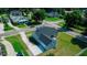 An aerial view displays the home's driveway and landscaping, set against a backdrop of lush greenery at 311 W Delaware Ave, Lake Helen, FL 32744