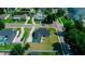 Aerial view of a well-kept, light blue single Gathering home with attached garage and long driveway at 311 W Delaware Ave, Lake Helen, FL 32744