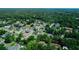 Picturesque aerial shot of a residential area featuring diverse homes surrounded by verdant landscaping at 311 W Delaware Ave, Lake Helen, FL 32744