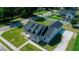 Aerial view of a light blue home with a dark roof, dormers, a front porch and a manicured lawn at 311 W Delaware Ave, Lake Helen, FL 32744