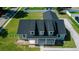 Aerial view displaying the roofline with dormer windows and the covered porch of the house in green neighborhood at 311 W Delaware Ave, Lake Helen, FL 32744