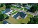 An aerial image displays home with wooden deck, neighborhood surroundings, and a neatly landscaped lawn at 311 W Delaware Ave, Lake Helen, FL 32744