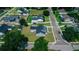 Aerial view of a well-kept, light blue single Gathering home with attached garage and long driveway at 311 W Delaware Ave, Lake Helen, FL 32744