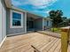 A backyard view showcases a wooden deck and partially covered patio at 311 W Delaware Ave, Lake Helen, FL 32744