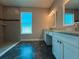 Bathroom features a tiled walk-in shower and dual vanities topped with granite counters at 311 W Delaware Ave, Lake Helen, FL 32744