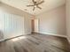 Bedroom featuring a ceiling fan, closet, and hardwood floors, creating a comfortable living space at 311 W Delaware Ave, Lake Helen, FL 32744
