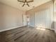 Bedroom featuring a ceiling fan, closet, hardwood floors, and doorway at 311 W Delaware Ave, Lake Helen, FL 32744