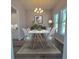 Elegant dining room with stylish lighting, modern furniture, and a view into the kitchen at 311 W Delaware Ave, Lake Helen, FL 32744