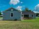 Back of the house featuring an outside deck and covered patio at 311 W Delaware Ave, Lake Helen, FL 32744