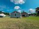 Back of light grey home showing yard and porch area at 311 W Delaware Ave, Lake Helen, FL 32744