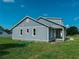 Side view of light grey home showing green lawn at 311 W Delaware Ave, Lake Helen, FL 32744
