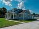 Charming home displaying a covered front porch, large windows, and clean architectural lines at 311 W Delaware Ave, Lake Helen, FL 32744