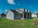 A charming light grey exterior view of the home on a sunny day at 311 W Delaware Ave, Lake Helen, FL 32744