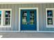 Close-up of a blue double-door entrance framed by white trim and matching windows at 311 W Delaware Ave, Lake Helen, FL 32744