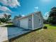 A detached garage with a white door on the property's side at 311 W Delaware Ave, Lake Helen, FL 32744
