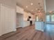 Modern kitchen with white cabinets, a large island, and stainless steel appliances at 311 W Delaware Ave, Lake Helen, FL 32744