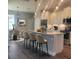 Open kitchen with an island, pendant lighting, modern appliances, and adjacent dining area at 311 W Delaware Ave, Lake Helen, FL 32744
