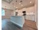 Bright, open kitchen features an island with granite counters, stylish pendant lighting and stainless steel appliances at 311 W Delaware Ave, Lake Helen, FL 32744