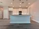 Modern kitchen featuring white cabinets, granite countertops, an island with pendant lights, and stainless steel appliances at 311 W Delaware Ave, Lake Helen, FL 32744