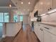Modern kitchen featuring white cabinets, granite countertops, and stainless steel appliances at 311 W Delaware Ave, Lake Helen, FL 32744