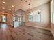 Open-concept living area with recessed lighting, light hardwood floors, and modern pendant lights over the island at 311 W Delaware Ave, Lake Helen, FL 32744