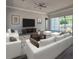 Bright living room featuring white sofas, modern decor, and large sliding glass doors at 311 W Delaware Ave, Lake Helen, FL 32744