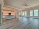 Open floor plan with wood-look floors, connecting the living room to the kitchen at 311 W Delaware Ave, Lake Helen, FL 32744