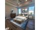 Cozy main bedroom featuring a well-dressed bed, stylish décor, and a ceiling fan for enhanced comfort at 311 W Delaware Ave, Lake Helen, FL 32744