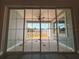 Patio with a ceiling fan and large glass doors leading to an outdoor area, offering seamless indoor-outdoor living at 311 W Delaware Ave, Lake Helen, FL 32744