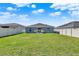 Large backyard with lush lawn, framed by a pristine white fence, offering privacy at 312 Inman Blvd, Winter Haven, FL 33881