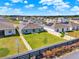A private, fenced backyard with a lush lawn, perfect for outdoor activities and relaxation, and solar panels on the roof at 312 Inman Blvd, Winter Haven, FL 33881