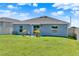 Backyard features a lawn, patio, and a view of the home's exterior at 312 Inman Blvd, Winter Haven, FL 33881