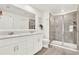 Bright bathroom features a double vanity with modern fixtures and a sleek glass-enclosed shower at 312 Inman Blvd, Winter Haven, FL 33881