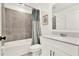 Bathroom with a white vanity, gray tiled backsplash, and shower with curtain at 312 Inman Blvd, Winter Haven, FL 33881