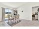 Cozy dining area with neutral tones, seating for four, and sliding door to outside at 312 Inman Blvd, Winter Haven, FL 33881