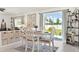 Dining room with a table, four chairs, neutral rug, and view of the backyard through a sliding glass door at 312 Inman Blvd, Winter Haven, FL 33881