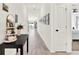 Hallway with wood-look floors, decorative table, and decor at 312 Inman Blvd, Winter Haven, FL 33881