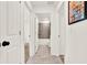 Hallway with open doorways to bathroom and bedroom at 312 Inman Blvd, Winter Haven, FL 33881