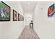 Well-lit hallway featuring wood-style tile flooring, and decorated with framed art at 312 Inman Blvd, Winter Haven, FL 33881