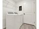 Well-lit laundry room with a modern washer and dryer, and convenient overhead shelving at 312 Inman Blvd, Winter Haven, FL 33881