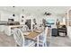 Open-concept living and dining area with modern kitchen, stainless appliances, and stylish decor at 312 Inman Blvd, Winter Haven, FL 33881