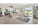 Bright living room with tile flooring, a ceiling fan, sliding glass doors and view to the backyard at 312 Inman Blvd, Winter Haven, FL 33881
