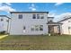The backyard features a well-maintained lawn and the home's modern exterior with a covered patio at 3121 Buffington Pl, Oviedo, FL 32765