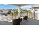 View from the covered balcony featuring composite flooring, seating, and neighborhood views at 3121 Buffington Pl, Oviedo, FL 32765